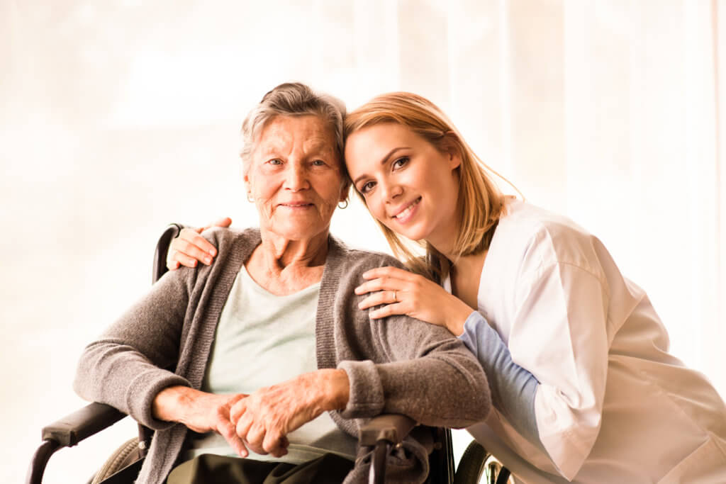 Health visitor and a senior woman during home visit.
