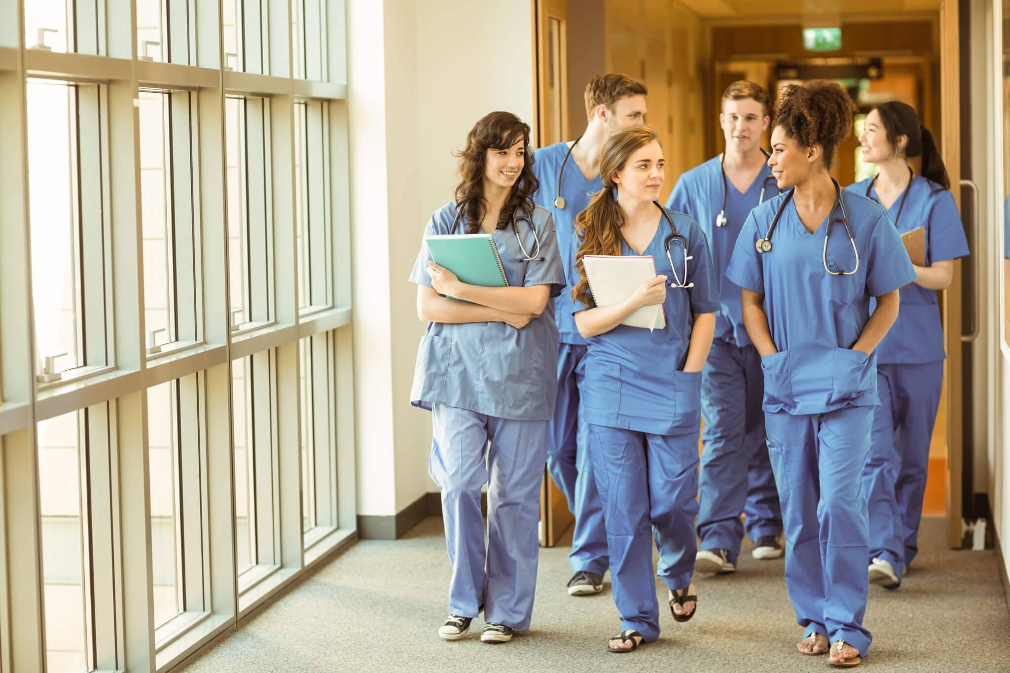 group of nurses walking in a hospital